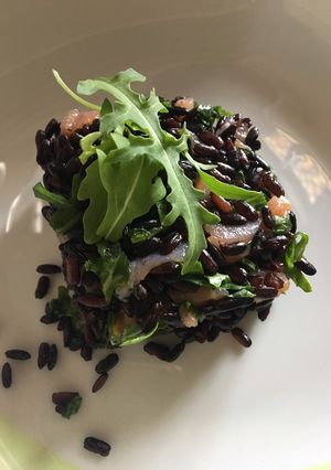A picture of Venere (Black) Rice with Arugula and Salmon.
