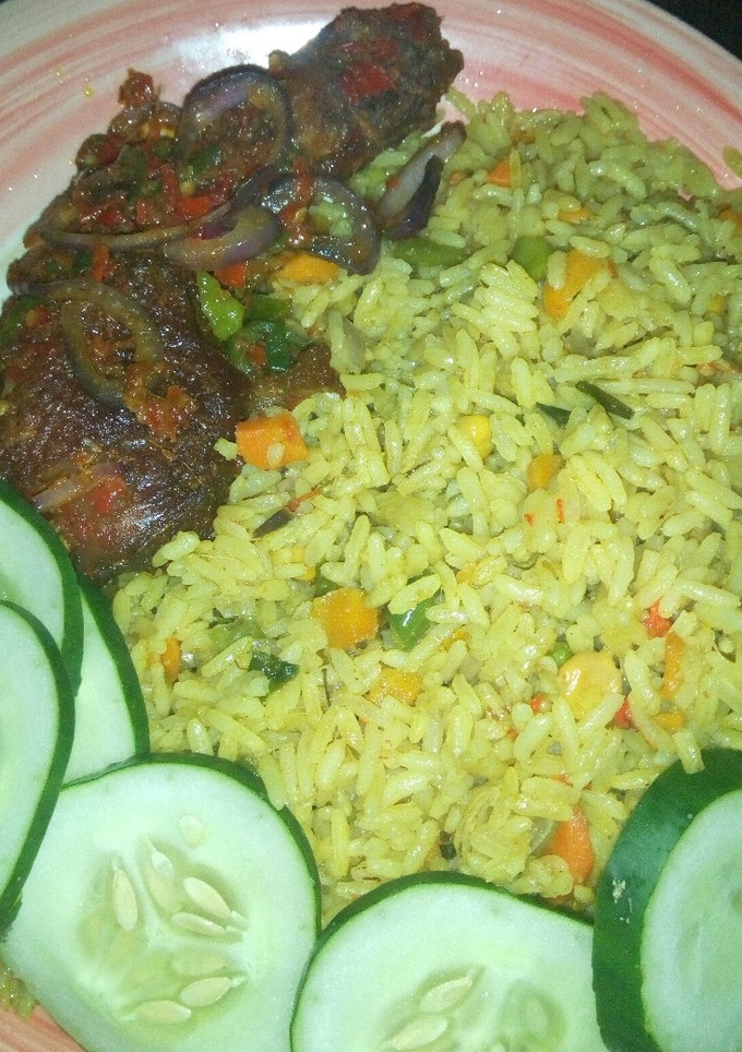 A picture of Fried rice with peppered chicken dressed with cucumber.