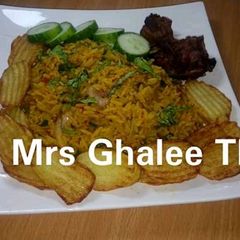 A picture of Jallof rice with chips and fry meat.