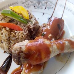 A picture of Chinese Stir fried Rice with stewed drumsticks.