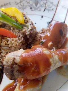 A picture of Chinese Stir fried Rice with stewed drumsticks.