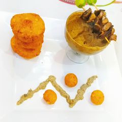 A picture of Chana dal falafel with kale chana hummus and burnt garlic sauce.