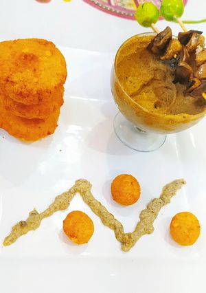 A picture of Chana dal falafel with kale chana hummus and burnt garlic sauce.