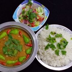 A picture of MOONG MASOOR Ke DAAL WITH BOILED RICE & SALAD.