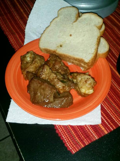 A picture of Pan fried pork and beef heart with bread.