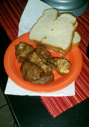 A picture of Pan fried pork and beef heart with bread.