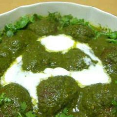 A picture of Malai Kofta with Spinach Gravy.