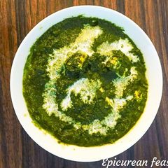A picture of Palak Paneer/ cottage cheese in spinach sauce.