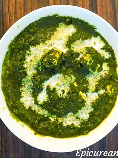 A picture of Palak Paneer/ cottage cheese in spinach sauce.