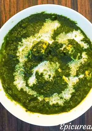 A picture of Palak Paneer/ cottage cheese in spinach sauce.