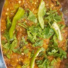 A picture of Cooked Eggplant bharta with peas.