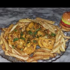 A picture of Chicken steem with french fries.