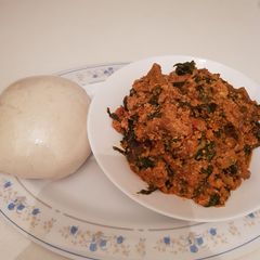 A picture of Egusi soup with spinach and tuwo shikafa.