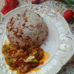 A picture of Rice and beans with sauce.