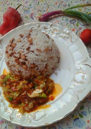 A picture of Rice and beans with sauce.