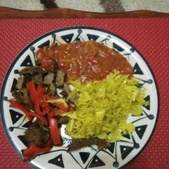 A picture of Stir fry steak with steamed cabbage and sauce.