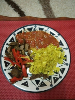 A picture of Stir fry steak with steamed cabbage and sauce.