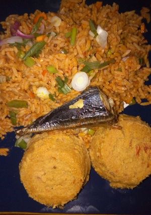 A picture of Jollof rice and moimoi.