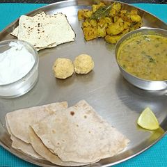 A picture of Typical Gujarati Thali with Mung Bean Curry.