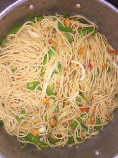 A picture of Spagetti with green pepper and carrots.