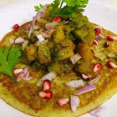 A picture of Moong dal pancake with spicy potatoes.