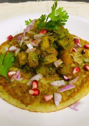 A picture of Moong dal pancake with spicy potatoes.