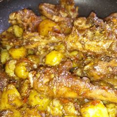 A picture of Chicken and potatoes mixed.