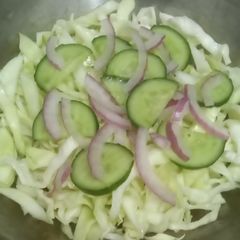 A picture of Salad, cabbage, cucumber, onion.