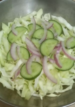 A picture of Salad, cabbage, cucumber, onion.