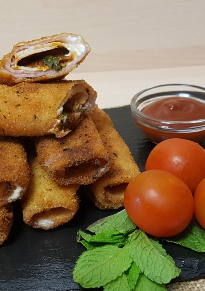 Una foto de Canutillos de embutido con tomate seco y hierbabuena