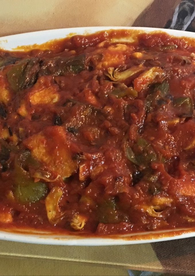 Una foto de Bacalao con tomate, pimientos y alcachofas