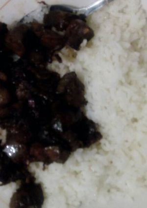A picture of White rice with fried liver.