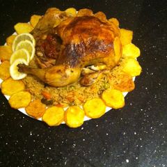 A picture of Roasted chicken with rice and veg.