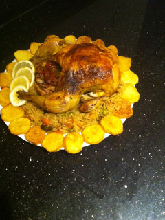 A picture of Roasted chicken with rice and veg.