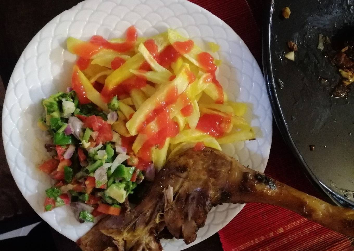 Roasted kienyenji chicken served chips and kachumbari