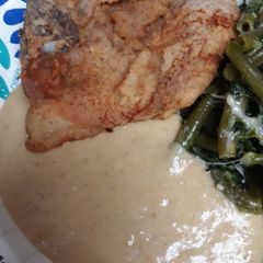 A picture of Down to the Bone Porkchop with Flavorful Gravy.