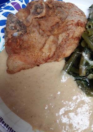 A picture of Down to the Bone Porkchop with Flavorful Gravy.