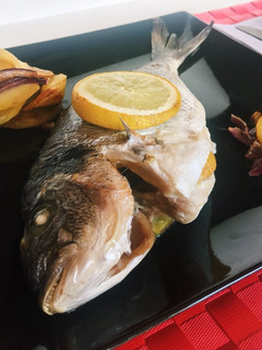 Una foto de Dorada al horno con patatas