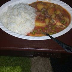 A picture of Beef stew and rice.