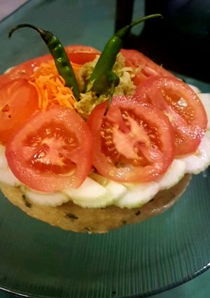A picture of Protein cake full of salad.