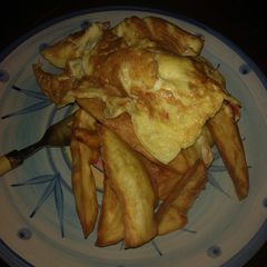 A picture of Fried sweet potatoes and egg.