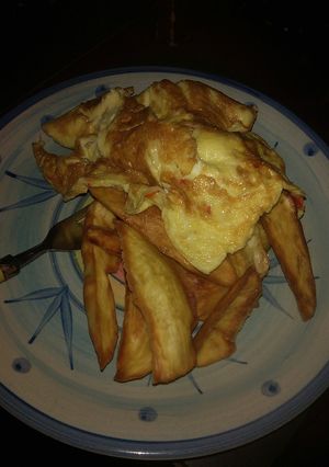 A picture of Fried sweet potatoes and egg.