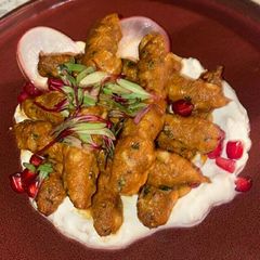 A picture of Soyabean rolls in white sauce.