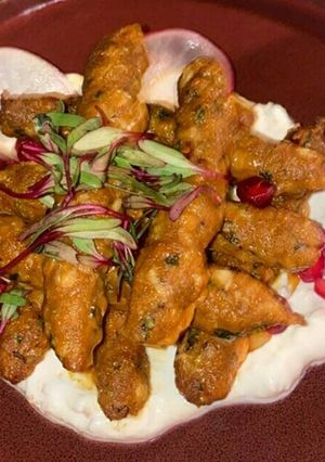 A picture of Soyabean rolls in white sauce.