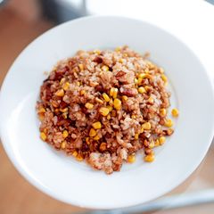 A picture of Corn and bacon fried rice with soy sauce.