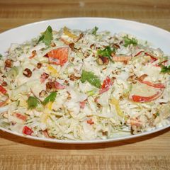 A picture of Cabbage salad with apples and pecan nuts.