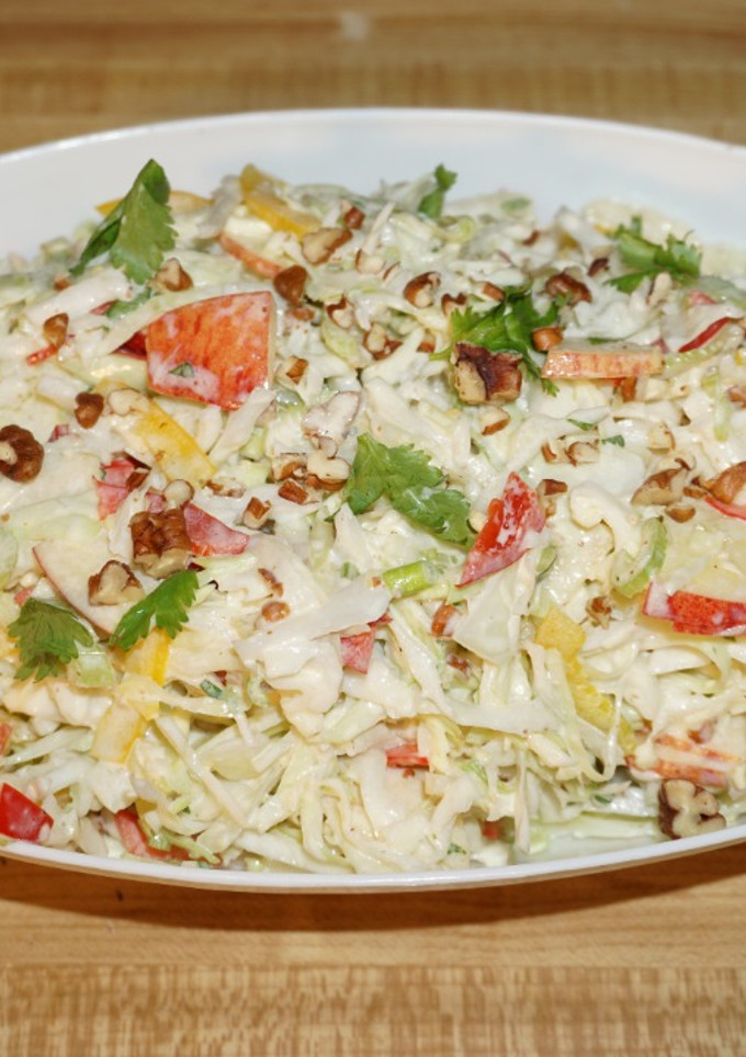 A picture of Cabbage salad with apples and pecan nuts.
