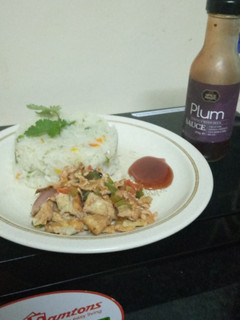 A picture of Braised rice with scrambled eggs,and plum sauce.