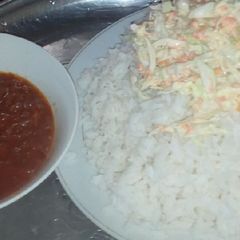 A picture of White rice, salad and tomatoes stew.