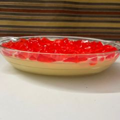 A picture of Vanilla custard with strawberry jello.